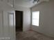 Bedroom view with neutral carpet, white walls, and a window with blinds at 3401 Conan St # 103, Las Vegas, NV 89129