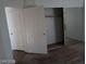 Bedroom featuring a mirrored sliding closet, neutral carpet, and white doors at 3401 Conan St # 103, Las Vegas, NV 89129