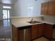 Kitchen featuring stainless steel dishwasher, double sink, and light wood cabinets at 3401 Conan St # 103, Las Vegas, NV 89129