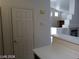 Open-concept living area with a fireplace and stairway adjacent to the breakfast bar at 3401 Conan St # 103, Las Vegas, NV 89129