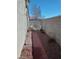 Side yard with a brick walkway, stone landscaping, and privacy walls at 3401 Conan St # 103, Las Vegas, NV 89129