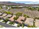 A residential street amid desert landscape, with well-maintained homes and mature trees at 35 Glade Water Dr, Henderson, NV 89052