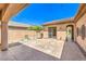 A back patio with string lighting, desert landscaping, and tan stucco walls at 35 Glade Water Dr, Henderson, NV 89052