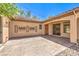 Spacious back patio featuring a stucco walls, desert landscaping, and decorative metal art at 35 Glade Water Dr, Henderson, NV 89052
