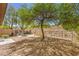 Landscaped backyard with desertscape gravel, a stone fire pit, and views of the surrounding hillside at 35 Glade Water Dr, Henderson, NV 89052