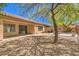A serene backyard featuring a stone patio and desert landscaping, perfect for outdoor entertaining at 35 Glade Water Dr, Henderson, NV 89052