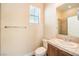 Neutral bathroom with a shower-over-tub setup and a single sink vanity with wood cabinets at 35 Glade Water Dr, Henderson, NV 89052