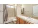 Neutral bathroom with a shower-over-tub setup and a single sink vanity with wood cabinets at 35 Glade Water Dr, Henderson, NV 89052