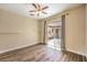Bright bedroom with neutral walls and wood-look floors featuring a sliding glass door to the patio at 35 Glade Water Dr, Henderson, NV 89052