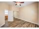 This spare bedroom has wood-look tiling and closet with sliding doors at 35 Glade Water Dr, Henderson, NV 89052