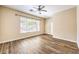 Spacious bedroom with a ceiling fan, large window, and wood-look flooring at 35 Glade Water Dr, Henderson, NV 89052