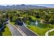 Aerial view of the pond water feature on the property surrounded by landscaping and mature trees at 35 Glade Water Dr, Henderson, NV 89052