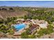 Elevated shot of the community pool area, featuring a sprawling pool, shaded seating, and mature trees at 35 Glade Water Dr, Henderson, NV 89052