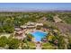 Aerial view of a large community pool surrounded by palm trees, lounge chairs, and lush landscaping at 35 Glade Water Dr, Henderson, NV 89052