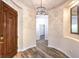 Stylish entryway featuring a wood door, chandelier, and wood grain flooring at 35 Glade Water Dr, Henderson, NV 89052