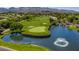 Scenic view of a golf course with a water feature and fountain, surrounded by lush greenery and hills at 35 Glade Water Dr, Henderson, NV 89052