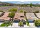 A well-maintained single-story home featuring a tile roof and manicured landscaping at 35 Glade Water Dr, Henderson, NV 89052