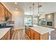 Well-equipped kitchen with island, stainless appliances, wooden cabinetry, and access to the living room at 35 Glade Water Dr, Henderson, NV 89052