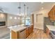 Open kitchen featuring an island, stainless steel appliances, and a view into the living room with fireplace at 35 Glade Water Dr, Henderson, NV 89052