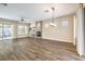 Open-concept living room with wood grain floors, fireplace, and plenty of natural light at 35 Glade Water Dr, Henderson, NV 89052