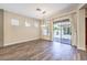 Living room featuring wood grain floors, neutral colors, and a sliding glass door at 35 Glade Water Dr, Henderson, NV 89052