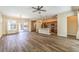 Spacious living room with open layout featuring hardwood floors, access to the kitchen, and outdoor patio at 35 Glade Water Dr, Henderson, NV 89052