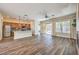 Open floor plan with wood flooring, modern kitchen, and access to outdoor space with sliding glass door at 35 Glade Water Dr, Henderson, NV 89052