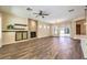 Cozy living area with a fireplace, wood flooring, and sliding glass door to the outside patio at 35 Glade Water Dr, Henderson, NV 89052
