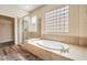 Spa-like main bathroom with soaking tub and glass-enclosed shower at 35 Glade Water Dr, Henderson, NV 89052
