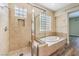 Beautiful bathroom featuring a glass shower and separate soaking tub at 35 Glade Water Dr, Henderson, NV 89052