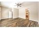 Spacious main bedroom with wood-look tile leading to main bathroom and walk-in closet at 35 Glade Water Dr, Henderson, NV 89052