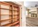 Spacious pantry features built-in wooden shelving, providing ample storage space, and easy access at 35 Glade Water Dr, Henderson, NV 89052