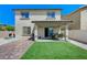 Home exterior showcasing a covered patio, artificial grass, and low-maintenance landscaping at 351 Nativo Ave, North Las Vegas, NV 89031