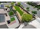 A beautiful aerial view of a landscaped backyard, with pavers, stone, covered patio, walking paths, lawn and mature trees at 351 Nativo Ave, North Las Vegas, NV 89031