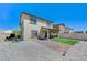 Exterior view of a home featuring a patio, artificial grass, and a low-maintenance gravel yard at 351 Nativo Ave, North Las Vegas, NV 89031