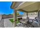 Covered patio area with a dining table overlooking the backyard's easy care landscaping at 351 Nativo Ave, North Las Vegas, NV 89031