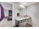 Bathroom vanity featuring ample counter space, a sink, and a large mirror, adjoining the bedroom at 351 Nativo Ave, North Las Vegas, NV 89031