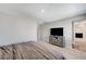 Bright bedroom featuring a TV, access to a bathroom, neutral carpet, and natural light at 351 Nativo Ave, North Las Vegas, NV 89031