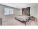 Bright bedroom featuring a modern bed frame, side table, and a large window for natural light at 351 Nativo Ave, North Las Vegas, NV 89031