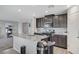 Modern kitchen featuring an island with a sink, stainless steel appliances, and access to the living area at 351 Nativo Ave, North Las Vegas, NV 89031
