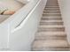 Carpeted staircase leading to the upper level, featuring a white handrail and neutral decor at 351 Nativo Ave, North Las Vegas, NV 89031