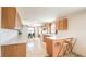 Well-lit kitchen offering ample cabinetry, countertop space, and seating at the breakfast bar at 3611 W Horn Rd, Pahrump, NV 89048