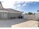 Spacious concrete backyard with a gate and various outdoor furniture pieces at 3684 Mooncrest Cir, Las Vegas, NV 89129