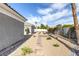 Side yard featuring desert landscaping, a stone pathway, and a well-maintained wall at 3684 Mooncrest Cir, Las Vegas, NV 89129