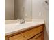 Close-up of a bathroom vanity with a large mirror and wood finish at 3684 Mooncrest Cir, Las Vegas, NV 89129