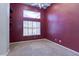 Bedroom with deep red accent wall and carpet flooring at 3684 Mooncrest Cir, Las Vegas, NV 89129