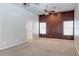 Spacious bedroom with ceiling fan, two windows, neutral walls, and carpeted floor at 3684 Mooncrest Cir, Las Vegas, NV 89129