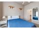 Cozy bedroom featuring a blue bedspread and a peek into the closet at 3684 Mooncrest Cir, Las Vegas, NV 89129