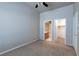 Another carpeted bedroom showing two access doors, neutral walls, and a ceiling fan at 3684 Mooncrest Cir, Las Vegas, NV 89129