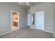 Another bedroom in the house showing neutral walls and carpeted floor, as well as an attached bathroom at 3684 Mooncrest Cir, Las Vegas, NV 89129